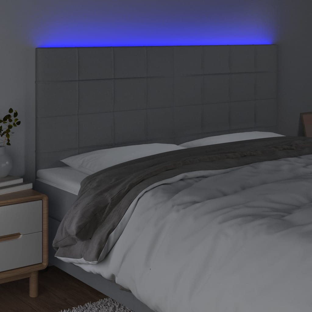 sengegavl med LED-lys 180x5x118/128 cm stof lysegrå