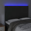 sengegavl med LED-lys 144x5x118/128 cm fløjl sort