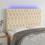 sengegavl med LED-lys 144x7x118/128 cm stof cremefarvet