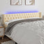sengegavl med LED-lys 183x16x78/88 cm stof cremefarvet