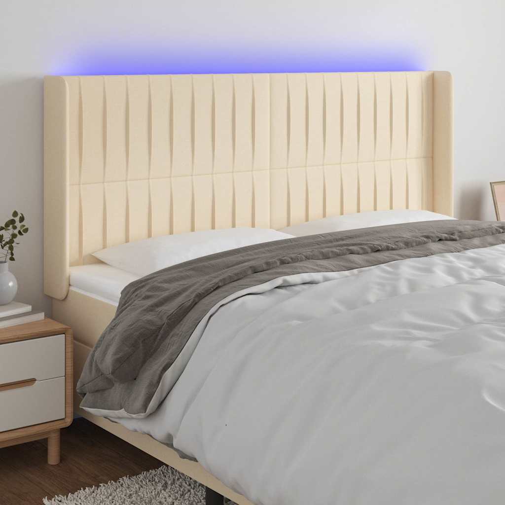 sengegavl med LED-lys 183x16x118/128 cm stof cremefarvet