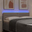 LED sengegavl med LED-lysstrimler Gråbrun 144 cm Stof